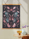 Hanging tapestry featuring a teal and pink butterfly surrounded by ginkgo-like leaves on a black background. The textile is suspended from wooden dowels with twine, creating detailed 3D embroidery-like texture.